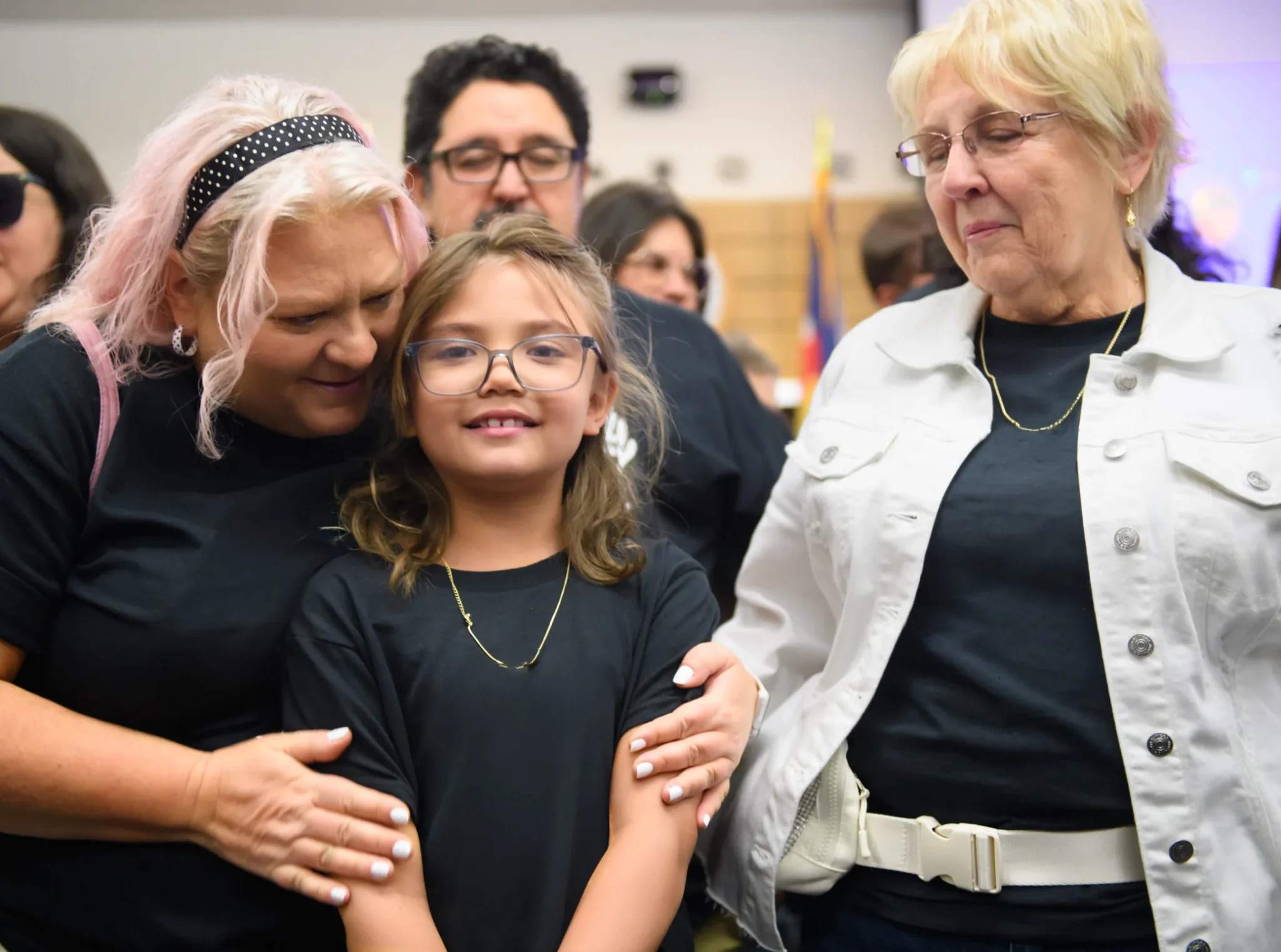 Volunteers providing support to a child in a foster family setting.